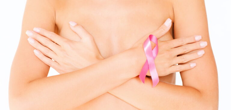 breast cancer awareness ribbon on bare chest covered